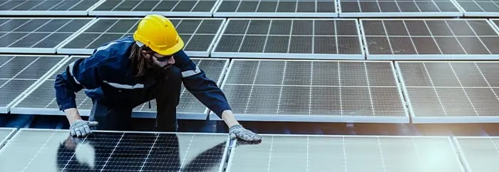 Specialist inspecting a solar system for faults or dirt